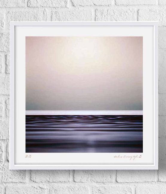 The Quiet Between — abstract photography by Andrew Conway-Hyde, London Fine Art Gallery Ltd. A pale rose-grey sky rests above a narrow band of dark, violet-toned water.